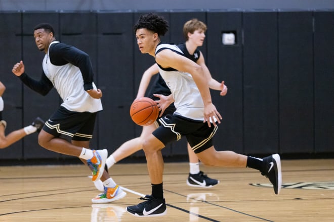 During a summer practice session in Boulder, freshman guard KJ Simpson dribbles the ball up court next to senior forward Evan Battey and freshman center Lawson Lovering in the background