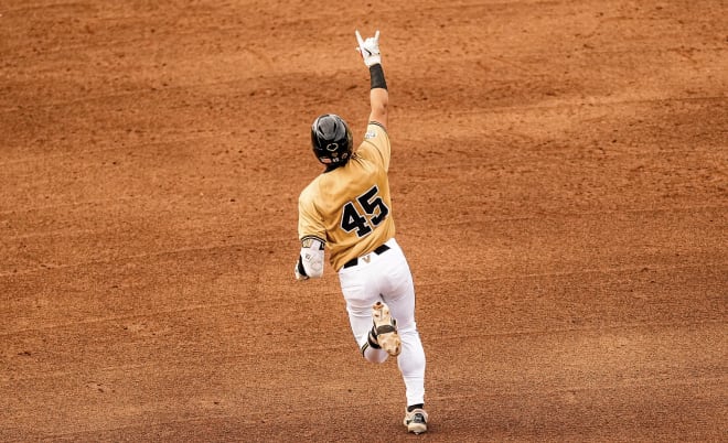 Alan Espinal celebrates one of his two home runs in Vanderbilt's rout of Tennessee.