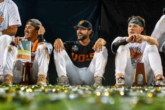 Jun 24, 2024; Omaha, NE, USA; Tennessee Volunteers center fielder Hunter Ensley (9), head coach Tony Vitello and third baseman Billy Amick (11) watch a video during postgame ceremonies after defeating the Texas A&M Aggies in the championship at Charles Schwab Field Omaha. Mandatory Credit: Dylan Widger-USA TODAY Sports