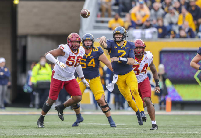 West Virginia Mountaineers quarterback Jarret Doege (2) throws a pass during the second quarter against the Iowa State Cyclones at Mountaineer Field at Milan Puskar Stadium.
