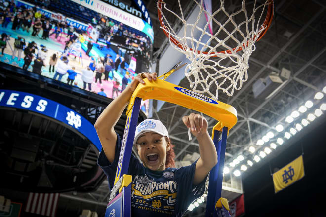 ACC Tournament MVP Hannah Hidalgo of Notre Dame climbs the ladder to help cut down the net Sunday in Greensboro, N.C.