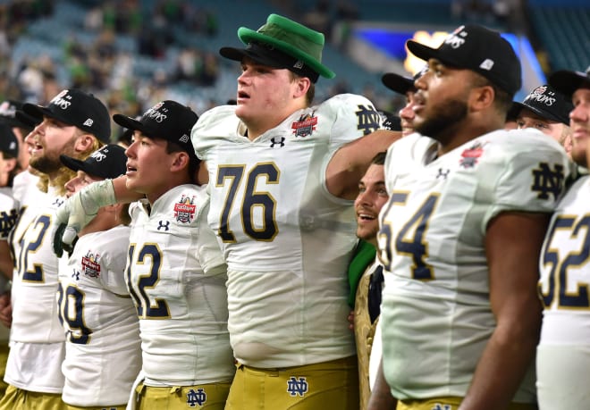 Irish left tackle Joe Alt (76) sings the Alma Mater with his Notre Dame teammates after their Gator Bowl win over South Carolina on Dec. 30.