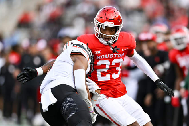 Houston Cougars defensive back Isaiah Hamilton (23) tackles Oklahoma State Cowboys running back Ollie Gordon II (0) during the second quarter at TDECU Stadium. Mandatory Credit: Maria Lysaker-USA TODAY Sports