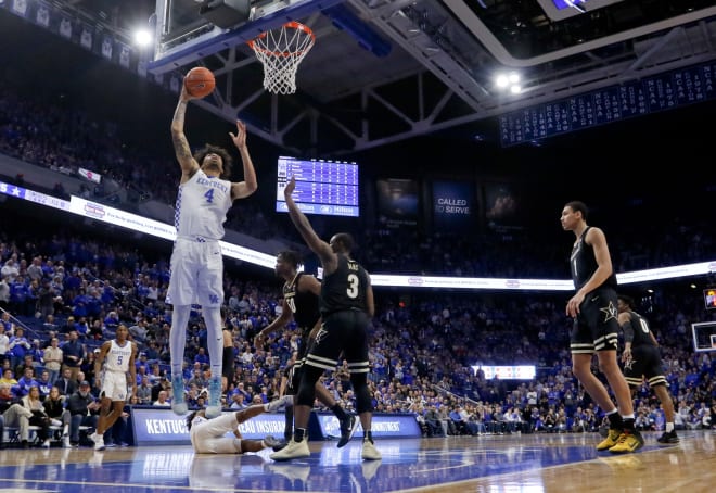 Vanderbilt players look on as Kentucky's Nick Richards makes a lay-up. 