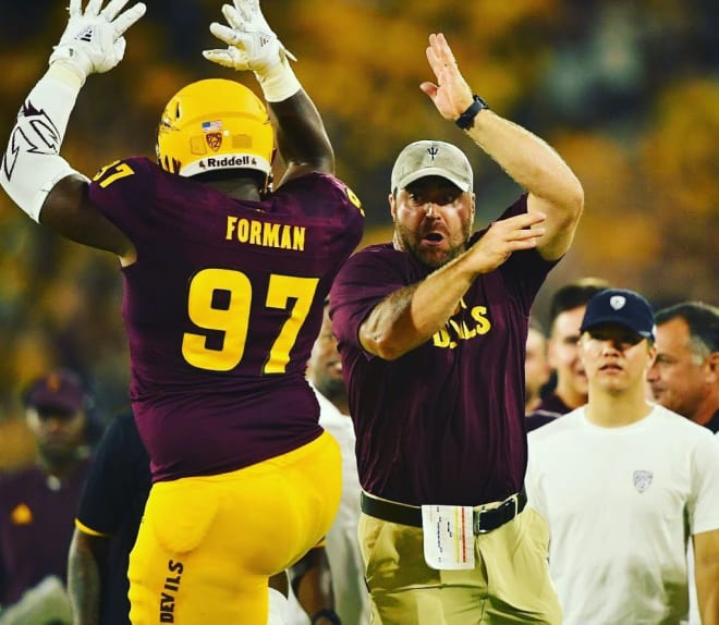 ASU Football's head coach for sports performance Joe Connolly celebrates a pick-six by DL Shannon Forman (97)