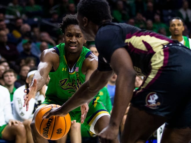 Notre Dame's Trey Wertz, wearing green, and Florida State's Chandler Jackson reach for the ball during the second half of FSU's win at ND.