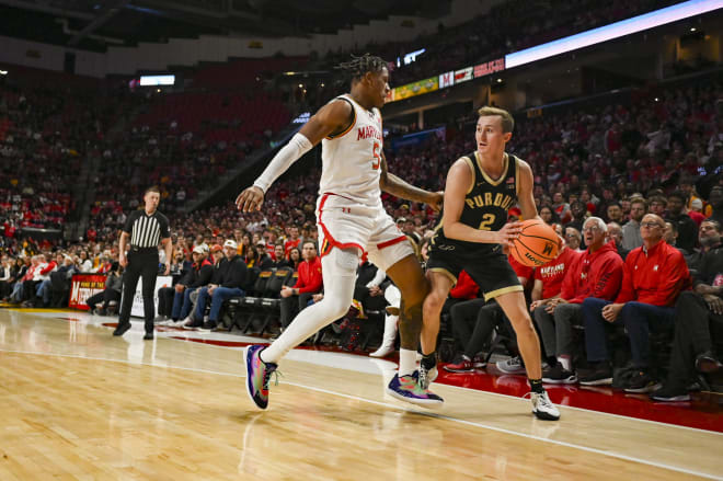 Jan 2, 2024; College Park, Maryland, USA; Purdue Boilermakers guard Fletcher Loyer (2) looks to pass as Maryland Terrapins guard DeShawn Harris-Smith (5) defends during the first half at Xfinity Center. Mandatory Credit: Tommy Gilligan-USA TODAY Sports