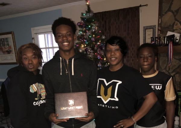 Safety Marquel Broughton with family after his signing