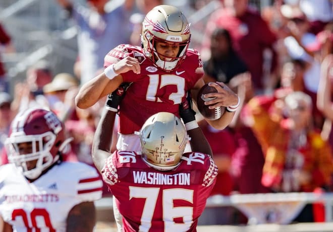 Florida State quarterback Jordan Travis celebrates a touchdown last Saturday with offensive tackle Darius Washington.