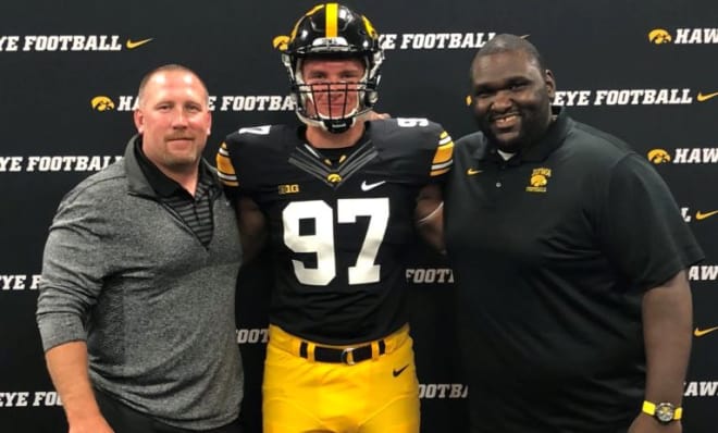 Class of 2020 defensive end Logan Wilson with Iowa coaches Tim Polasek and Kelvin Bell.