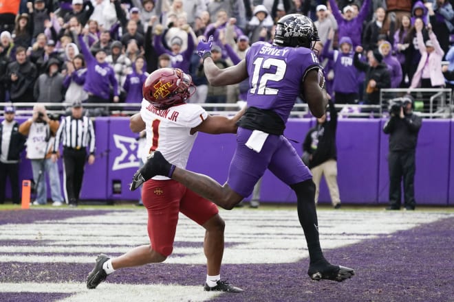 Nov 26, 2022; Fort Worth, Texas, USA; TCU Horned Frogs tight end Geor'Quarius Spivey (12) makes the 19-yard touch catch defended by Iowa State Cyclones defensive back Anthony Johnson Jr. (1) during first half at Amon G. Carter Stadium.