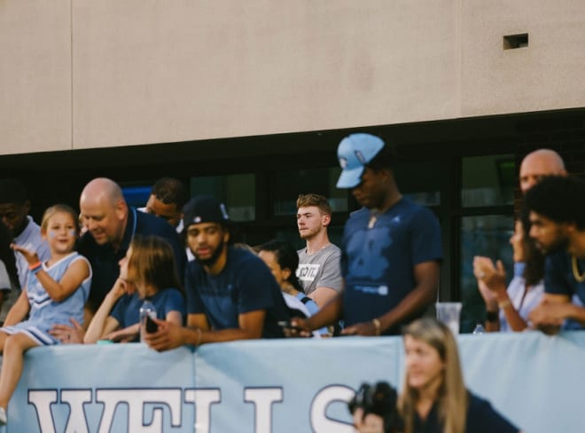 Tyler Nickel (center, greay shirt), met with Roy Williams before taking in Saturday's football game.