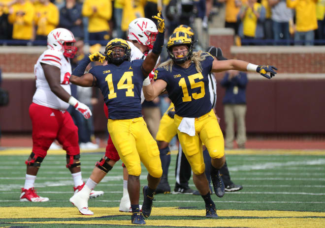 Junior safety Josh Metellus (No. 14) and fifth-year senior defensive end Chase Winovich led the way for a suffocating defensive performance.