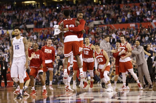 Wisconsin players celebrate after an NCAA Final Four tournament college basketball semifinal game against Kentucky Saturday, April 4, 2015, in Indianapolis. Wisconsin won 71-64.