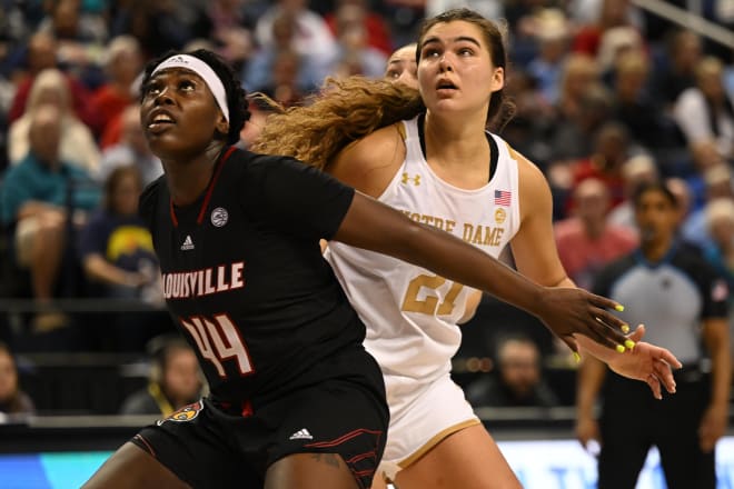 Louisville's Olivia Cochran (44) and Notre Dame's Maddy Westbeld (21) battle for position during an ACC Tourney semifinal game on Saturday.