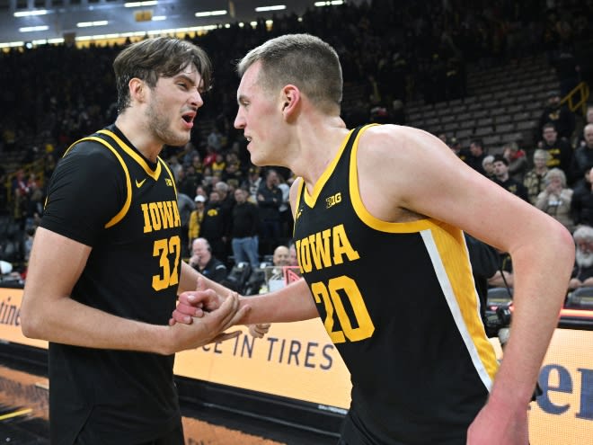 Owen Freeman and Payton Sandfort celebrate after defeating Wisconsin, 88-86 in overtime. 
