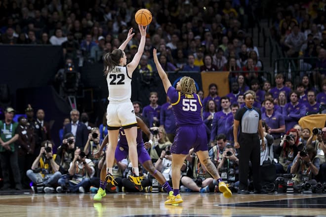 Iowa Hawkeyes guard Caitlin Clark (22) attempts a three-point basket against LSU Lady Tigers guard Kateri Poole (55) in the first half during the final round of the Women's Final Four NCAA tournament at the American Airlines Center.