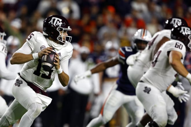 Texas A&M quarterback Conner Weigman (15) rolls out to pass against Auburn during the first half of an NCAA college football game Saturday, Nov. 12, 2022, in Auburn, Ala. (AP Photo/Butch Dill)