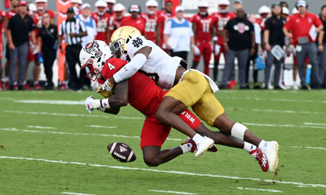 Notre Dame defensive back Thomas Harper separates NC State's Porter Rooks (4) from a pass thrown his way.