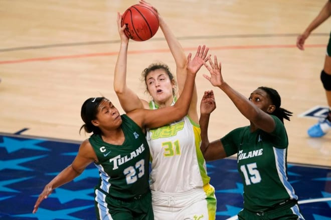 South Florida center Beatriz Jordao (31) grabs a rebound between Tulane forward Krystal Freeman, left, and forward Anijah Grant, right, during the second half of an NCAA college basketball game in the semifinal round of the American Athletic Conference women's tournament.