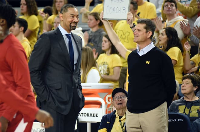 Michigan Wolverines basketball coach Juwan Howard (left) and football coach Jim Harbaugh.