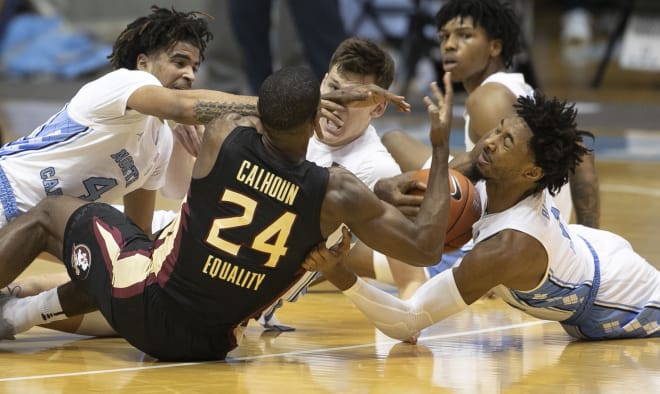 FSU's Sardaar Calhoun scraps for a loose ball Saturday with a group of North Carolina players.