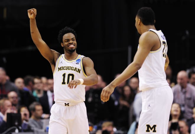 Former Michigan Wolverines basketball stars Derrick Walton and Zak Irvin celebrate an NCAA Tournament victory over Oklahoma State in 2017.