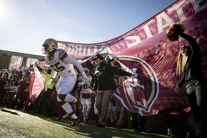 FSU defensive end Derrick McLendon races out onto the field Saturday at Boston College.