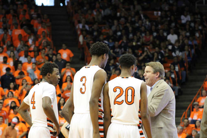 Tim Floyd talks to his team during a timeout
