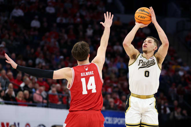 Mar 16, 2024; Minneapolis, MN, USA; Purdue Boilermakers forward Mason Gillis (0) shoots as Wisconsin Badgers forward Carter Gilmore (14) defends during the first half at Target Center. Mandatory Credit: Matt Krohn-USA TODAY Sports