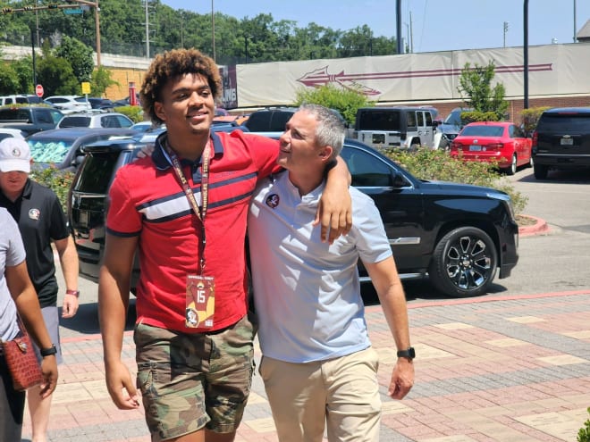 Four-star defensive end Keldric Faulk enjoys a moment with head coach Mike Norvell during his official visit.