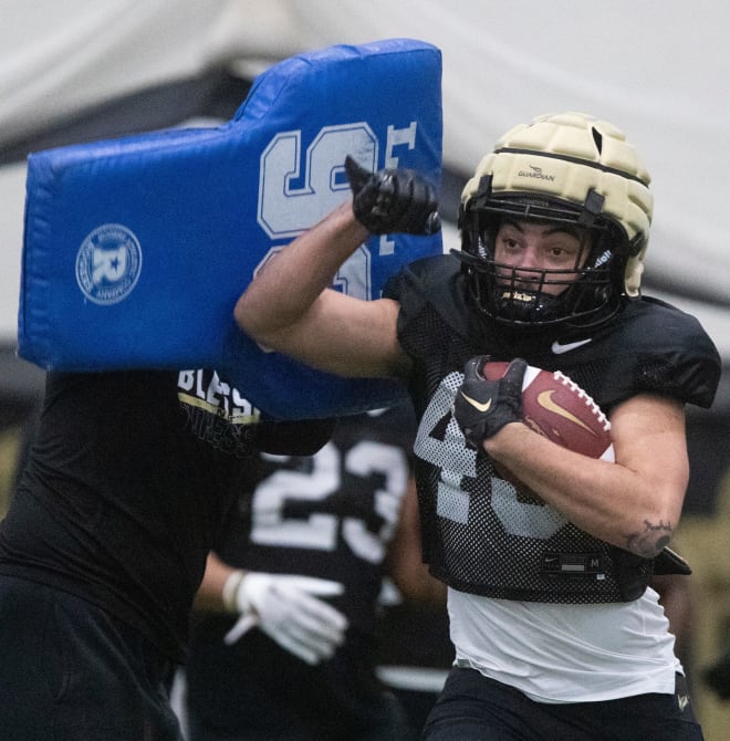 Purdue Boilermakers running back Devin Mockobee (45) runs a drill during practice, Tuesday, March 26, 2024, at Mollenkopf Athletic Center in West Lafayette, Ind.