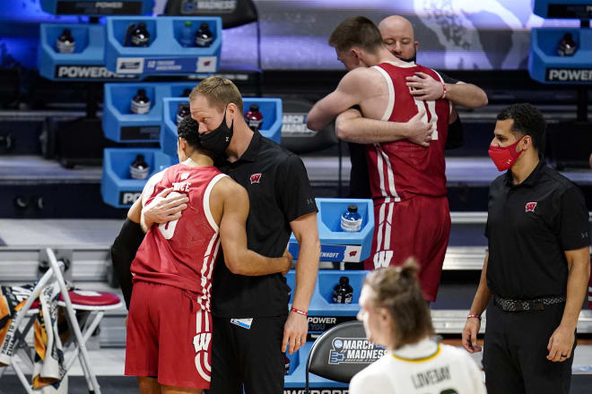 Wisconsin guard D'Mitrik Trice (0) and forward Micah Potter (11) hugs members of the basketball staff after leaving the game in the second half of a second-round game against Baylor.