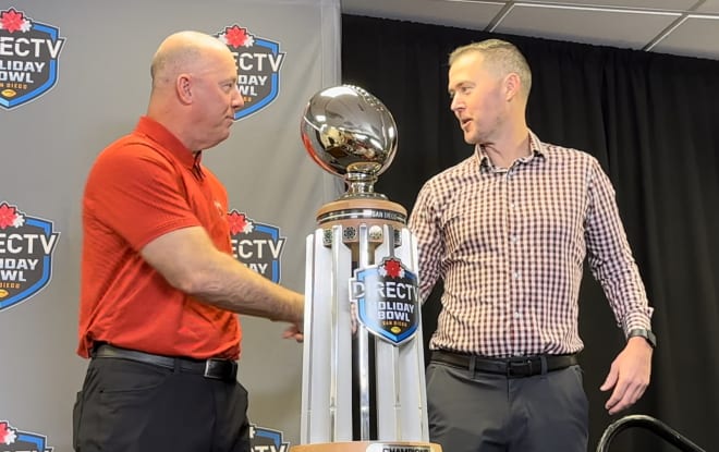 Louisville coach Jeff Brohm, left, and USC coach Lincoln Riley shake hands after their pre-Holiday Bowl press conference.