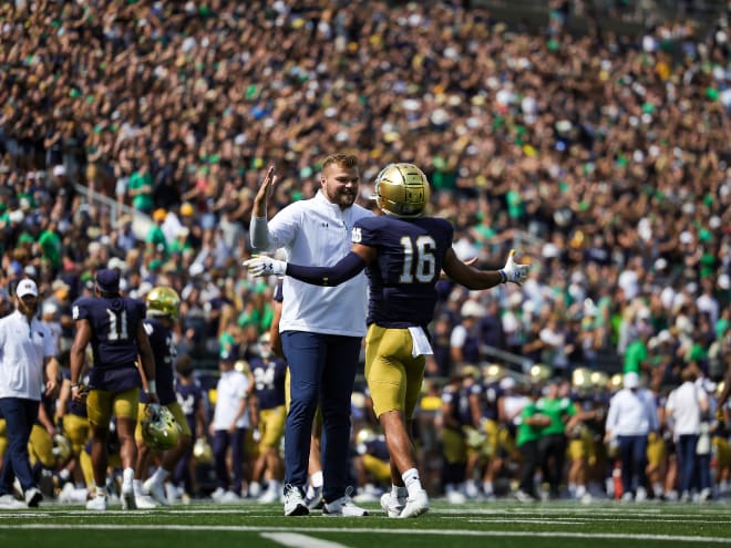 Hunter Bivin, left, greets safety Brandon Joseph prior to a Notre Dame game prior to the 2022 season.
