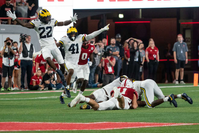 Michigan Wolverines players celebrate an interception at Nebraska