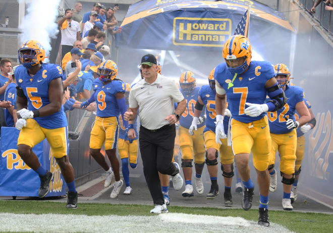 Pat Narduzzi takes the field with his Pittsburgh team before a win against Syracuse this season. 