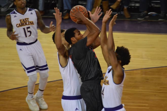 SMU's Sterling Brown shoots over ECU's Elijah Hughes and Andre Washington in a 75-44 win.