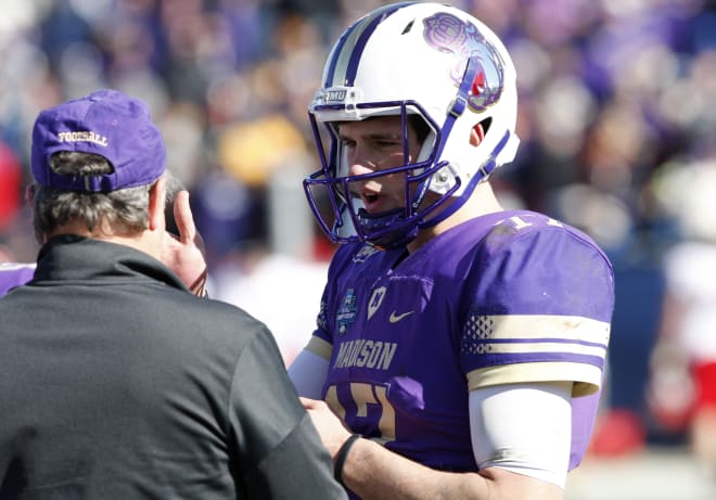 James Madison quarterback Bryan Schor (right) talks with offensive coordinator Donnie Kirkpatrick during the Dukes' championship win over Youngstown State last week in Frisco, Texas.