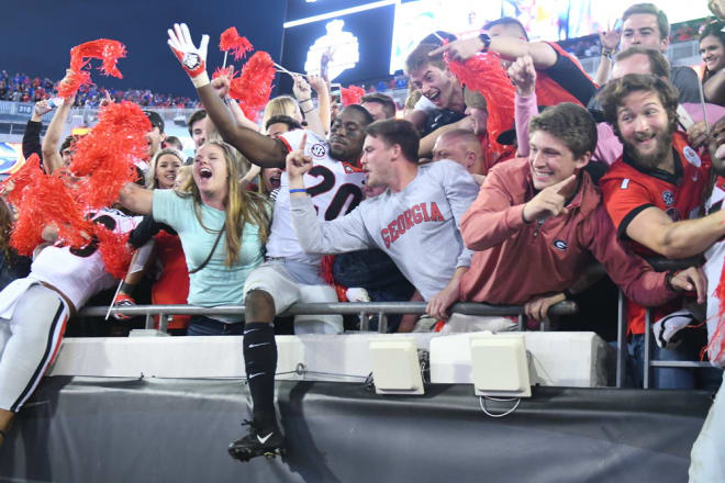 J.R. Reed celebrates Georgia's win with fans.