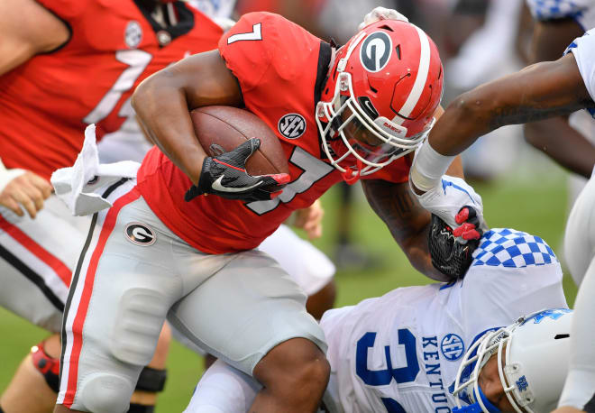 Georgia's D'Andre Smith runs through the Kentucky defense in the first half of Saturday's game in Athens, Ga.