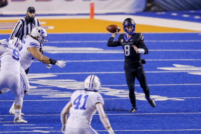 Boise State quarterback Cade Fennegan (8) looks for a receiver as the BYU defense closes in during the first half of an NCAA college football game Friday, Nov. 6, 2020, in Boise, Idaho. (AP Photo/Steve Conner)