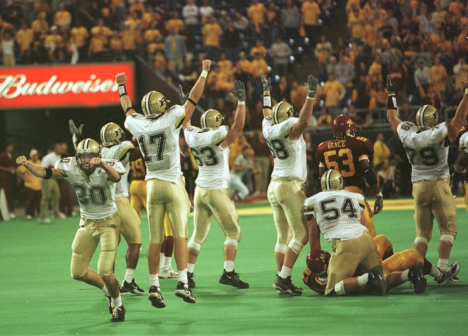 All-American place-kicker Travis Dorsch (30), holder Ben Smith (17) and the offensive line react after making the game-tying field goal as time expired.
