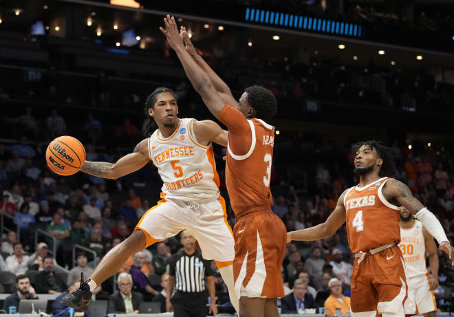 March 23, 2024, Charlotte, NC, USA; Tennessee Volunteers guard Zakai Zeigler (5) passes the ball away from Texas Longhorns guard Max Abmas (3) in the second round of the 2024 NCAA Tournament at the Spectrum Center.