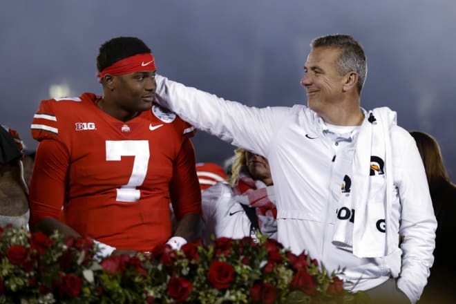 Coach Urban Meyer and redshirt sophomore quarterback Dwayne Haskins embrace following the Rose Bowl