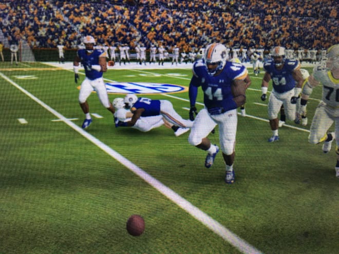 Derick Hall follows through after a strip-sack, planting the QB as Daquan Newkirk (44) prepares to take the loose ball for a 20-yard, scoop-and-score touchdown.