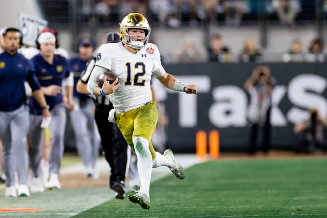 Notre Dame Fighting Irish quarterback Tyler Buchner (12) runs with the ball to the sideline during the second half against the South Carolina Gamecocks in the 2022 Gator Bowl at TIAA Bank Field. Photo | Matt Pendleton-USA TODAY Sports