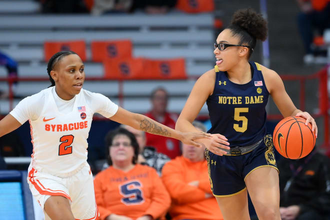  Notre Dame guard Olivia Miles (5) controls the ball as Syracuse's Dyaisha Fair (2) defends during a 72-56 Irish road victory on Sunday.