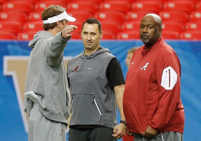 Alabama offensive coordinator Lane Kiffin speaks with Steve Sarkisian and Mike Locksley during practice for the Chick-fil-A Peach Bowl College Football Playoff semifinal at the Georgia Dome in Atlanta, Ga. on Wednesday, Dec. 28, 2016.