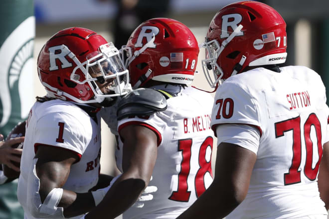 Oct 24, 2020; East Lansing, Michigan, USA; Rutgers Scarlet Knights running back Isaih Pacheco (1) celebrates with wide receiver Bo Melton (18) and offensive lineman Reggie Sutton (70) after rushing for a touchdown during the first quarter against the Michigan State Spartans at Spartan Stadium. Mandatory Credit: Raj Mehta-USA TODAY Sports